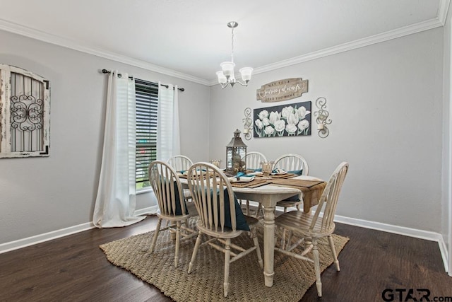 dining area featuring dark wood finished floors, crown molding, baseboards, and an inviting chandelier