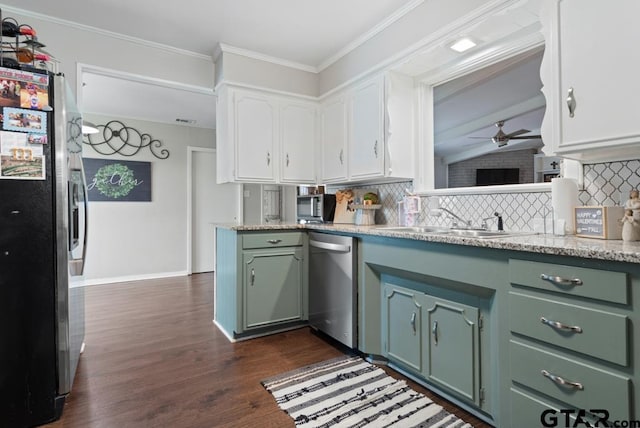 kitchen with stainless steel appliances, a sink, white cabinetry, tasteful backsplash, and crown molding