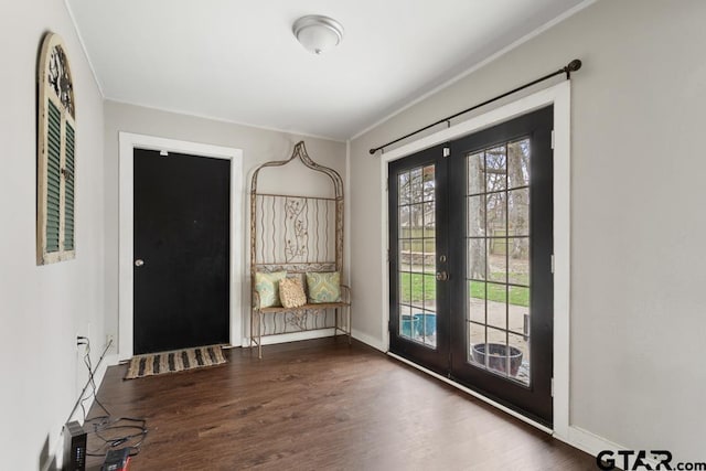 entrance foyer featuring baseboards, french doors, dark wood-style flooring, and crown molding