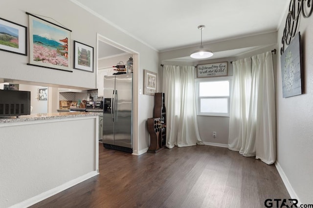 kitchen featuring decorative backsplash, stainless steel fridge with ice dispenser, ornamental molding, dark wood-style flooring, and decorative light fixtures