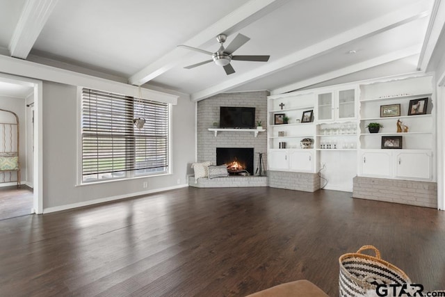 unfurnished living room with baseboards, lofted ceiling with beams, ceiling fan, dark wood-type flooring, and a fireplace