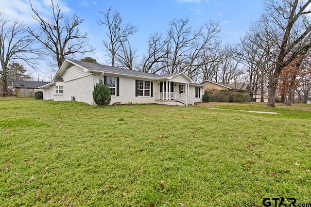 view of front of house featuring a front lawn and brick siding