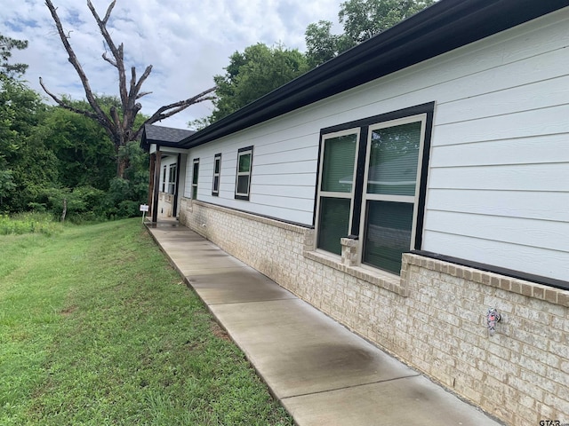 501 W Vance St, Tyler, TX 75702 - view of side of home with a lawn and brick siding