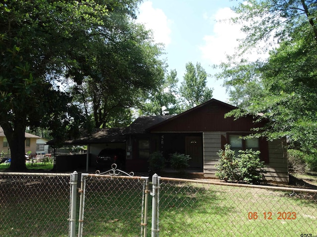 ranch-style home with a carport and a front yard