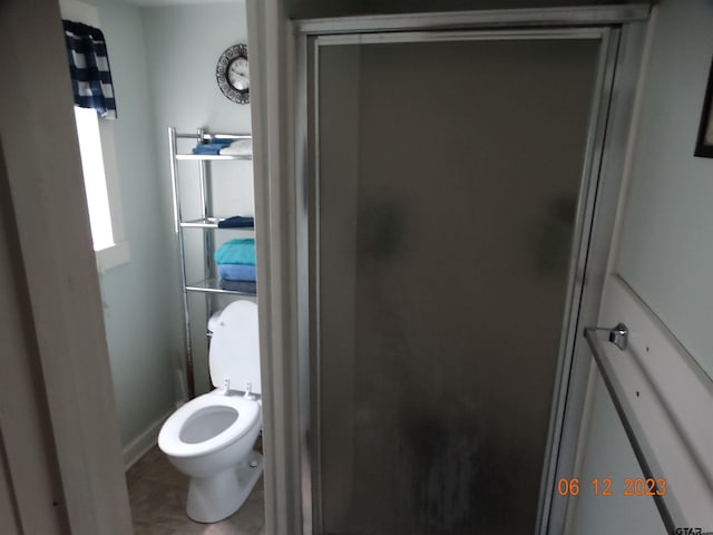 bathroom with tile patterned floors and toilet