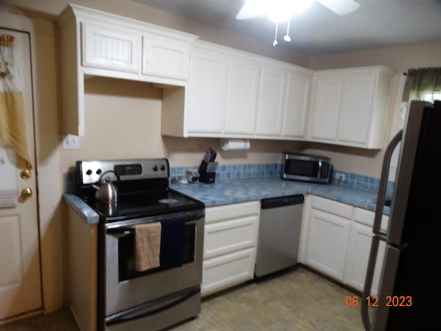 kitchen with white cabinets, ceiling fan, and stainless steel appliances