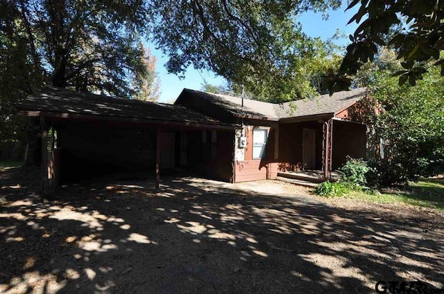 back of property with a carport