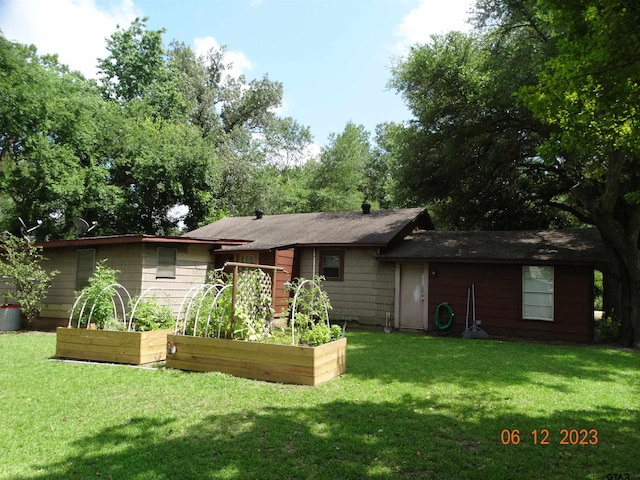 rear view of property with a lawn