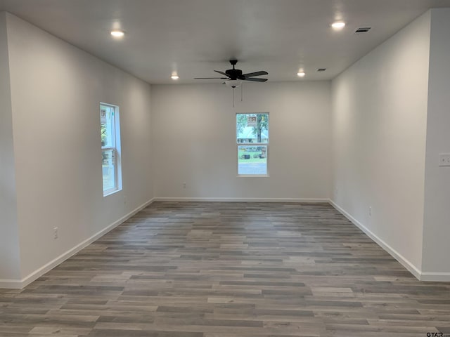 unfurnished room with hardwood / wood-style flooring, plenty of natural light, and ceiling fan