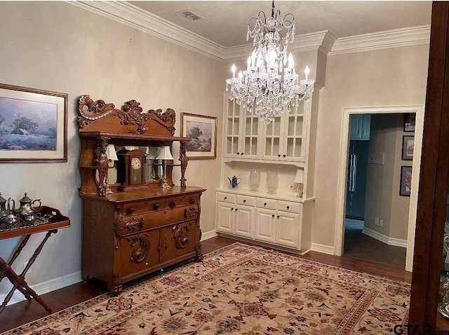 dining space featuring crown molding, a chandelier, and dark hardwood / wood-style floors