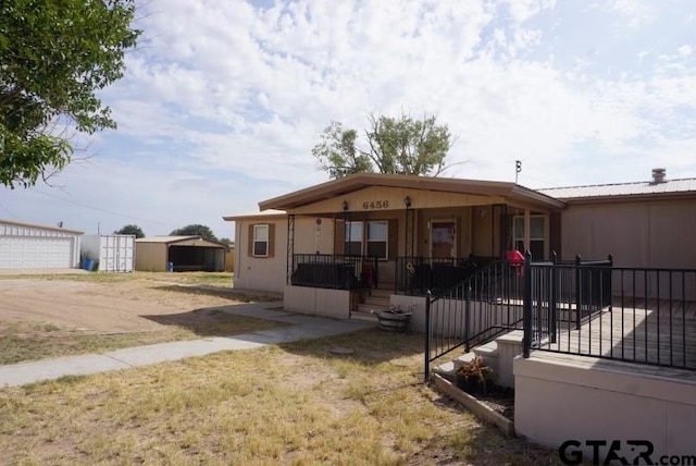 view of front facade featuring an outbuilding and a garage