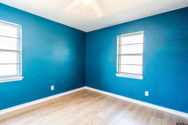 empty room with ceiling fan and light wood-type flooring