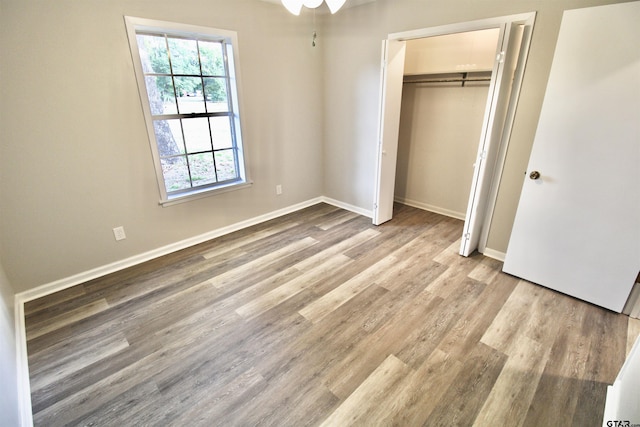 unfurnished bedroom featuring light hardwood / wood-style flooring and a closet