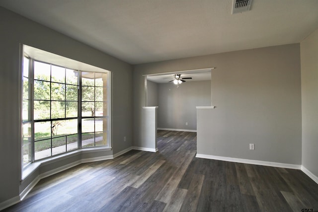 spare room with ceiling fan and dark wood-type flooring