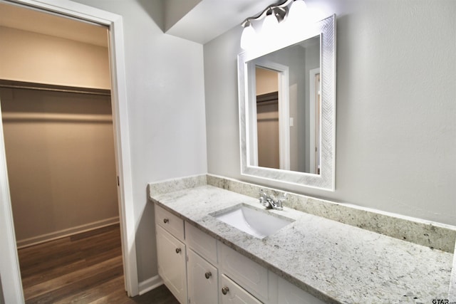 bathroom with vanity and hardwood / wood-style flooring