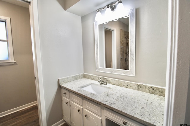 bathroom with hardwood / wood-style floors and vanity