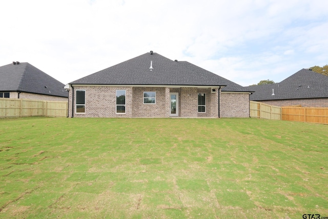 rear view of house with a lawn