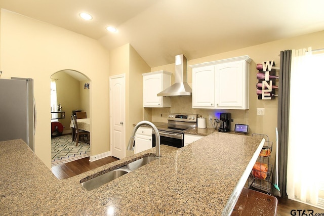 10821 Cactus Trl, Flint, TX 75762 - kitchen with wall chimney exhaust hood, appliances with stainless steel finishes, dark wood-type flooring, white cabinetry, and light stone countertops