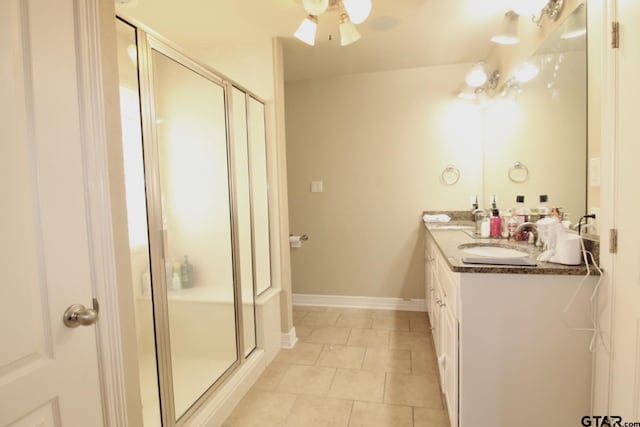 10821 Cactus Trl, Flint, TX 75762 - bathroom with double vanity, a shower stall, tile patterned floors, and ceiling fan