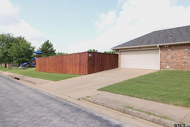 10821 Cactus Trl, Flint, TX 75762 - view of side of property with brick siding, a yard, concrete driveway, a shingled roof, and an attached garage
