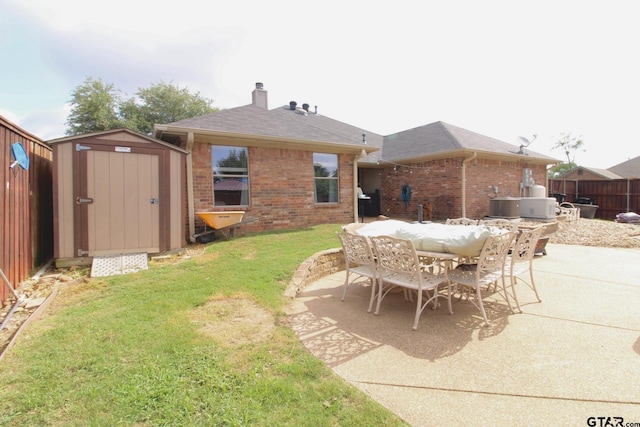 10821 Cactus Trl, Flint, TX 75762 - rear view of house featuring brick siding, a patio, a storage shed, a chimney, and outdoor dining area