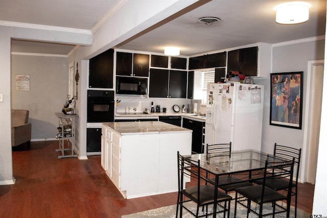 kitchen with dark cabinets, a kitchen island, visible vents, black appliances, and crown molding