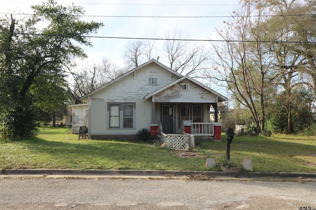 bungalow featuring a porch and a front yard