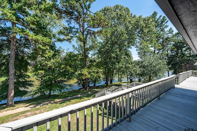 wooden terrace featuring a yard