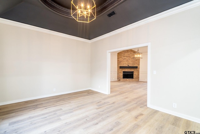 unfurnished living room with ornamental molding, a fireplace, and hardwood / wood-style flooring