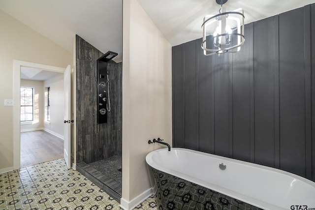 bathroom with a notable chandelier, independent shower and bath, hardwood / wood-style flooring, and vaulted ceiling