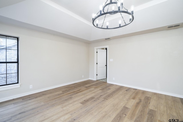 unfurnished dining area with light wood-type flooring and an inviting chandelier