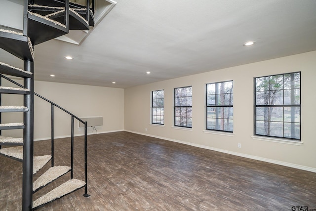 interior space with a wealth of natural light and dark wood-type flooring