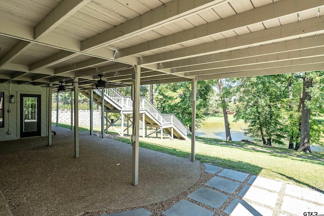 view of patio / terrace with a water view and ceiling fan