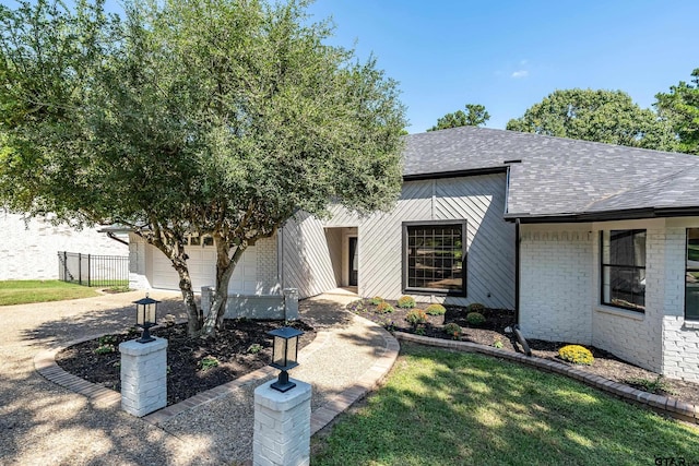 view of front of home with a garage and a front lawn