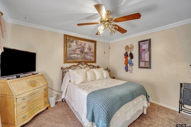 carpeted bedroom featuring ceiling fan and crown molding