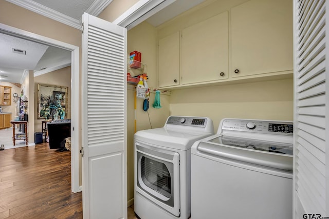 washroom featuring cabinets, a textured ceiling, separate washer and dryer, and dark hardwood / wood-style floors