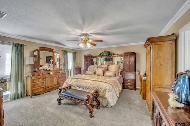 bedroom featuring ceiling fan, crown molding, light carpet, and a textured ceiling