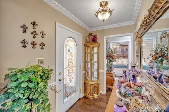 entryway with a textured ceiling, dark hardwood / wood-style floors, and crown molding