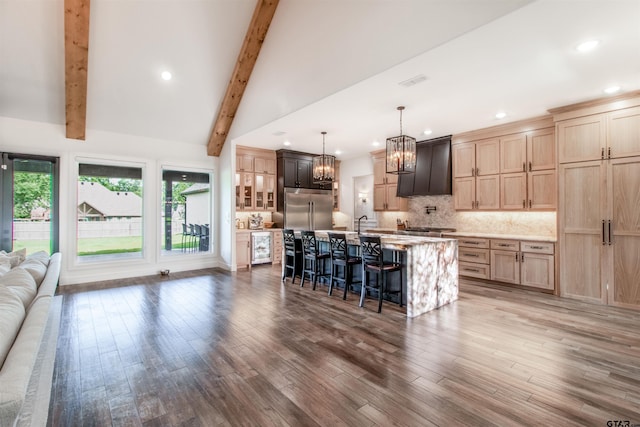 12240 Jazmin Cir, Flint, TX 75762 - kitchen featuring appliances with stainless steel finishes, a chandelier, a kitchen bar, tasteful backsplash, and wood finished floors