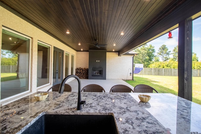 12240 Jazmin Cir, Flint, TX 75762 - view of patio / terrace with french doors, a ceiling fan, a large fireplace, and outdoor dining space