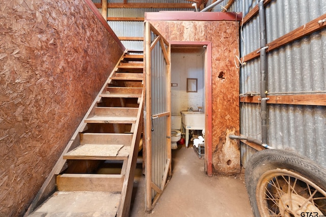 stairs featuring concrete floors