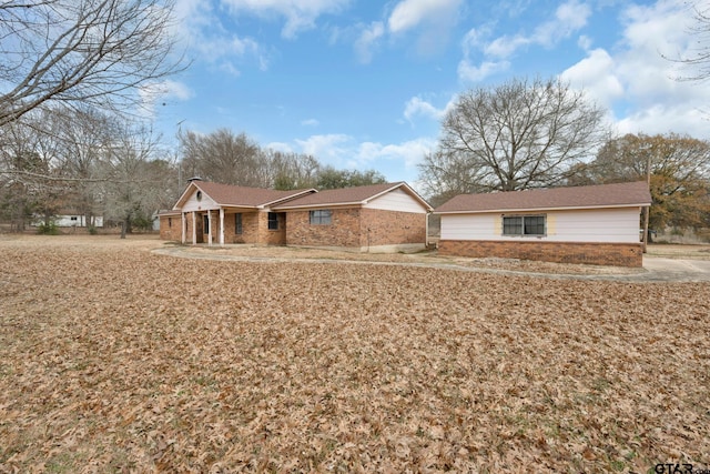 ranch-style house featuring brick siding