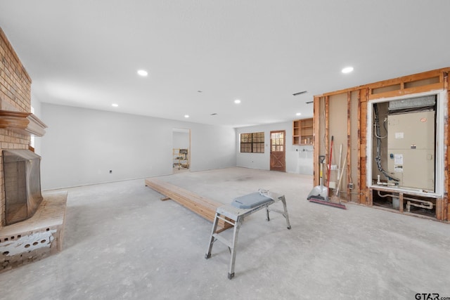 rec room featuring recessed lighting, a brick fireplace, and concrete floors