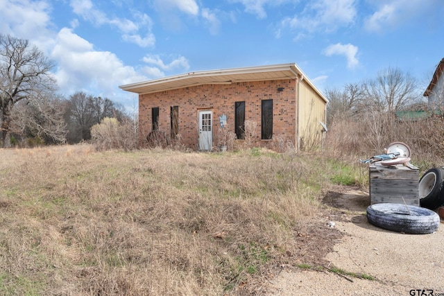 exterior space featuring brick siding