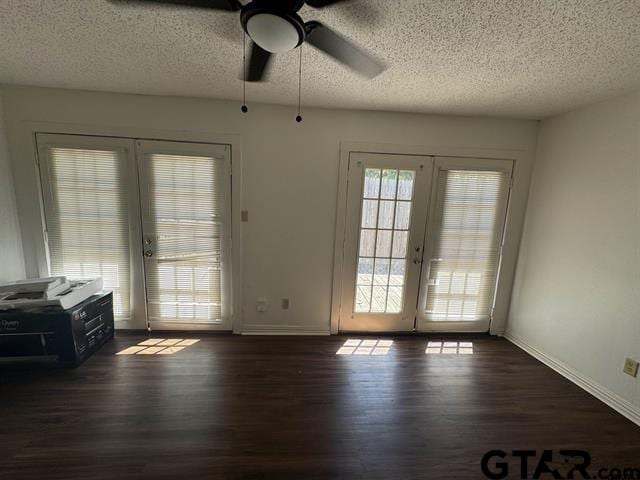 entryway with ceiling fan, dark hardwood / wood-style flooring, a textured ceiling, and french doors