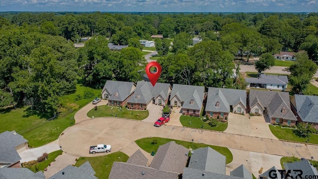 1216 Cobblestone Ct, Carthage, TX 75633 - aerial view of residential area featuring a heavily wooded area