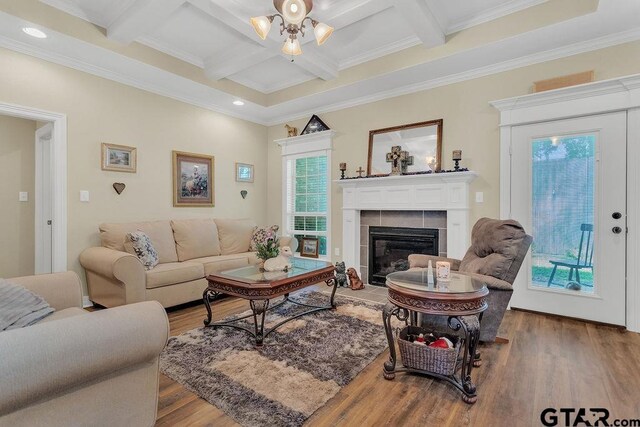 1216 Cobblestone Ct, Carthage, TX 75633 - living room with wood finished floors, beam ceiling, coffered ceiling, a fireplace, and crown molding