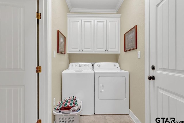 1216 Cobblestone Ct, Carthage, TX 75633 - laundry area featuring washing machine and dryer, cabinet space, and ornamental molding