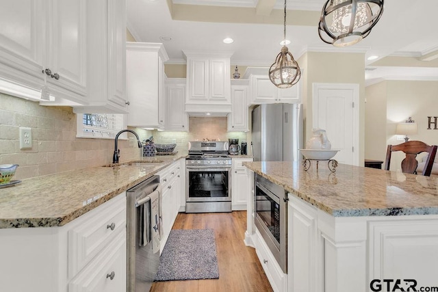 1216 Cobblestone Ct, Carthage, TX 75633 - kitchen with stainless steel appliances, a center island, white cabinets, ornamental molding, and light stone counters