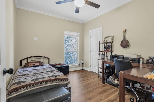 1216 Cobblestone Ct, Carthage, TX 75633 - bedroom with wood finished floors, a desk, ornamental molding, and a ceiling fan